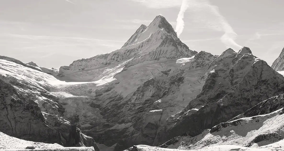 A scenic mountain peak rises above an alpine lake.